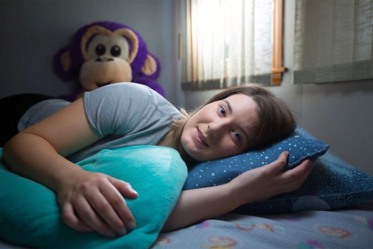 Professional snuggler Samantha Varnerin poses in her bedroom in Medford, Mass.
