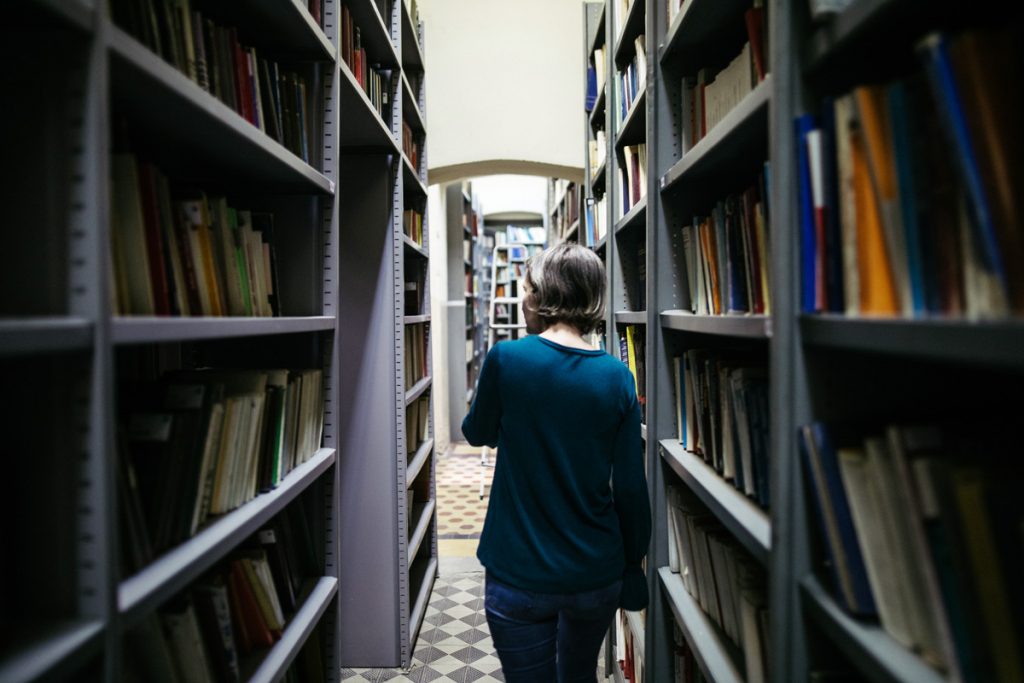 A librarian searches for a book.