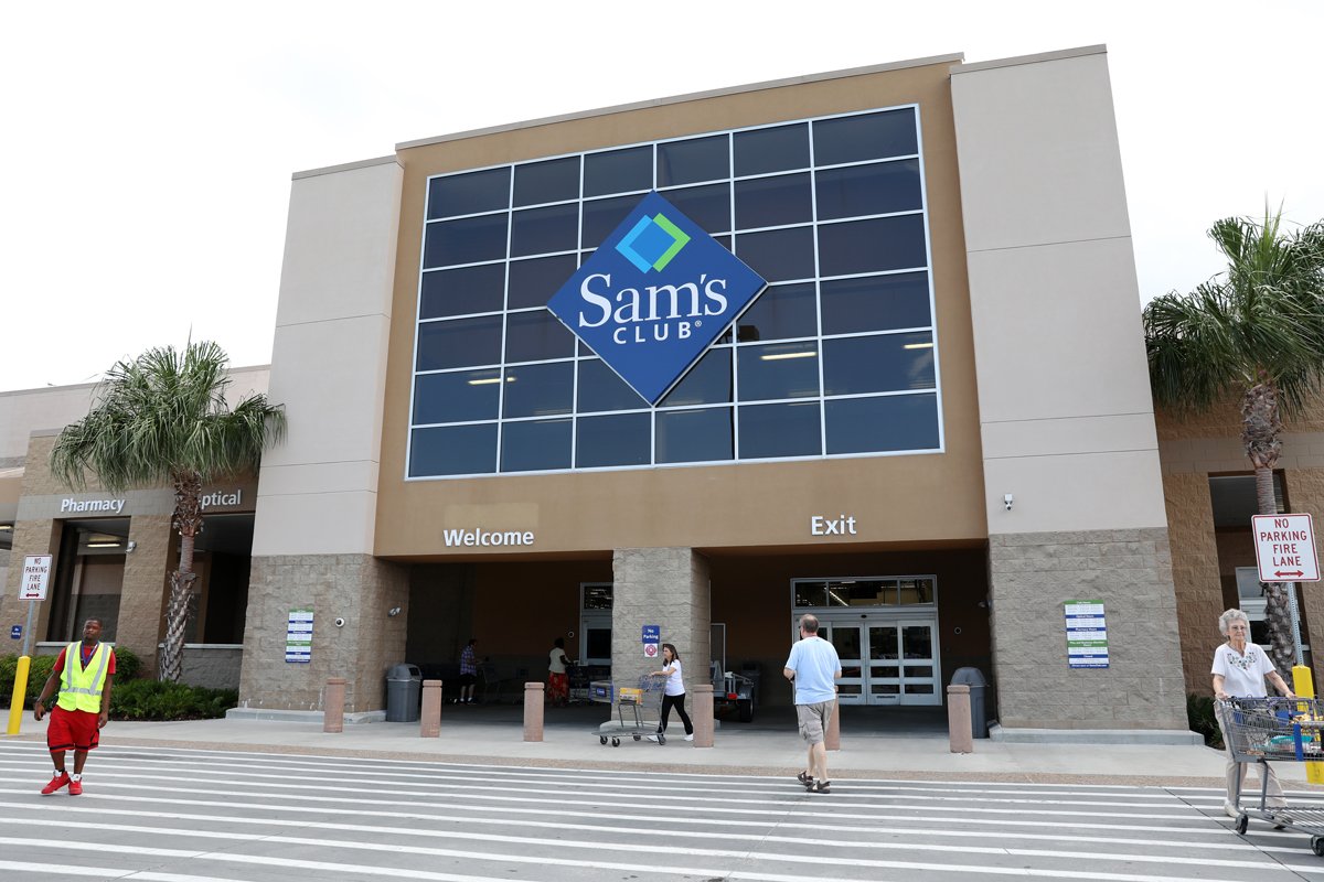 People walk outside of a Sam's Club.