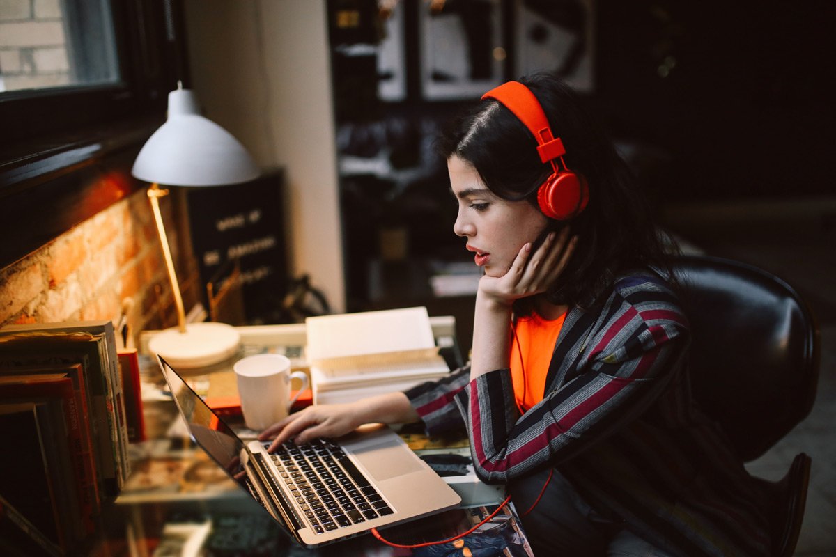 A woman transcribes documents on her laptop.