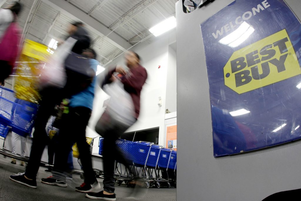 People walk into Best Buy.