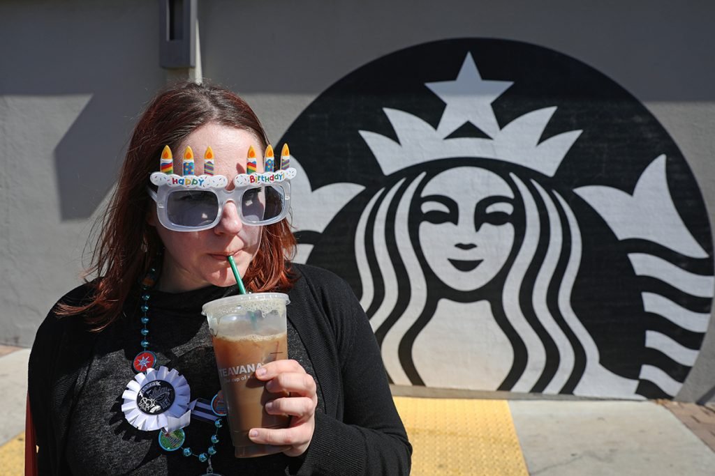 Robin Hartill, an editor at The Penny Hoarder, sips an iced coffee she got for free on her birthday at Starbucks in Saint Petersburg, Fla.