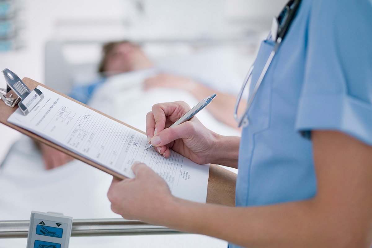 Nurse tending patient in intensive care