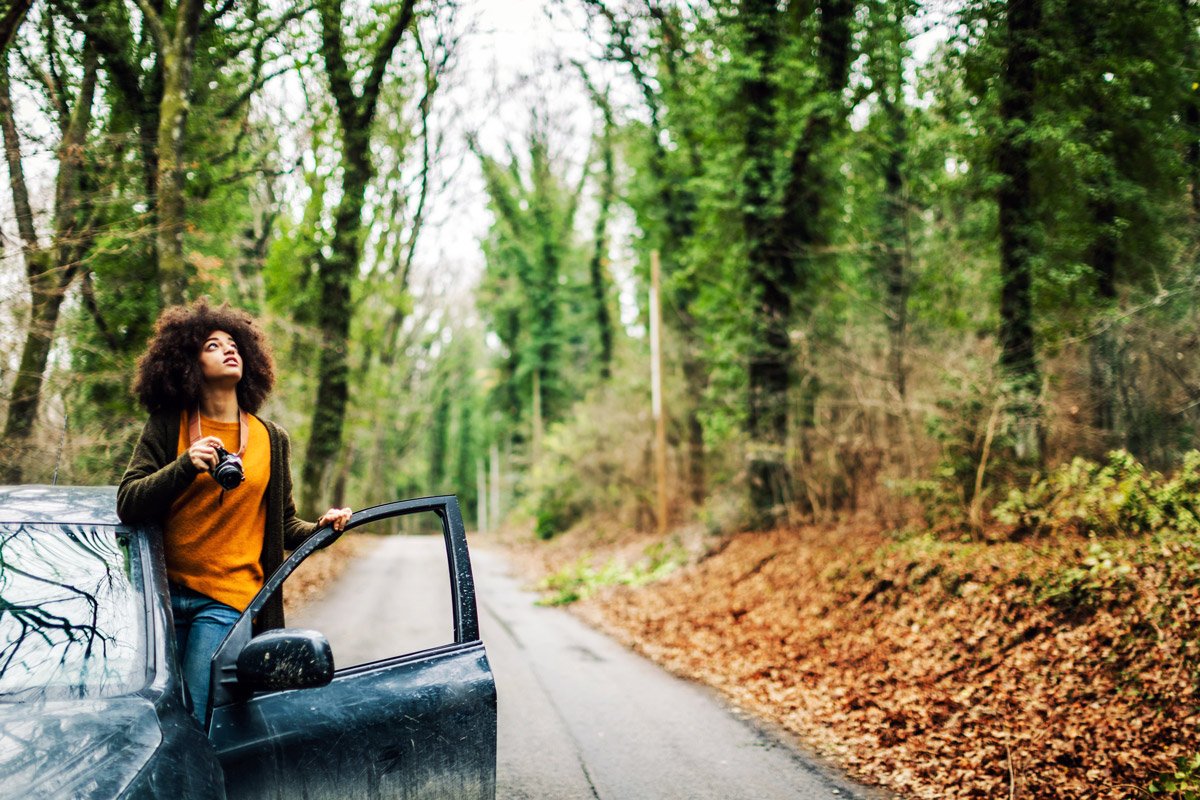 A woman takes photos while working out of her vehicle.
