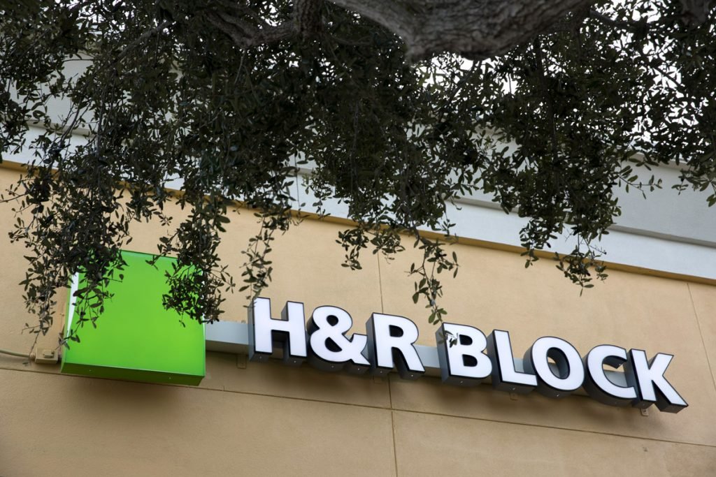 Trees offer shade around an H&R Block building.