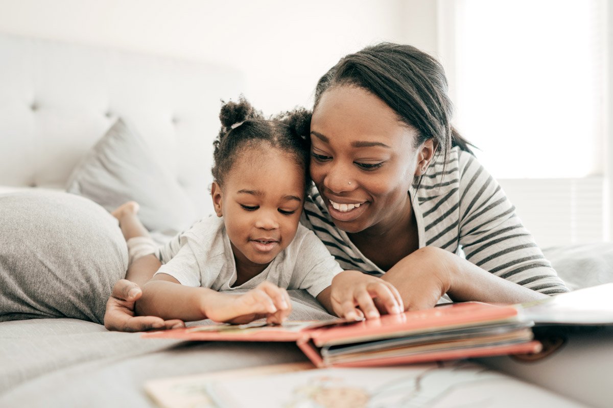 A mother reads to her toddler. 
