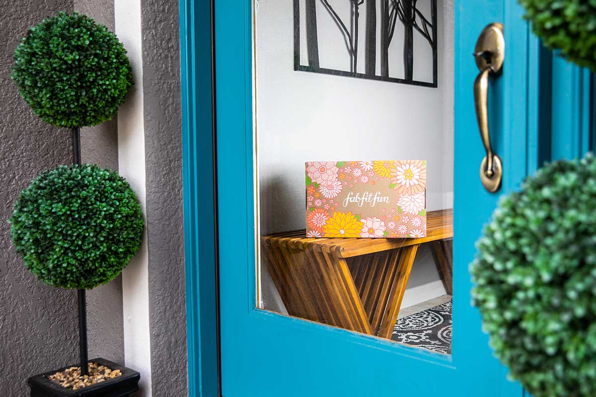 A fab fit fun box is pictured inside a door frame.