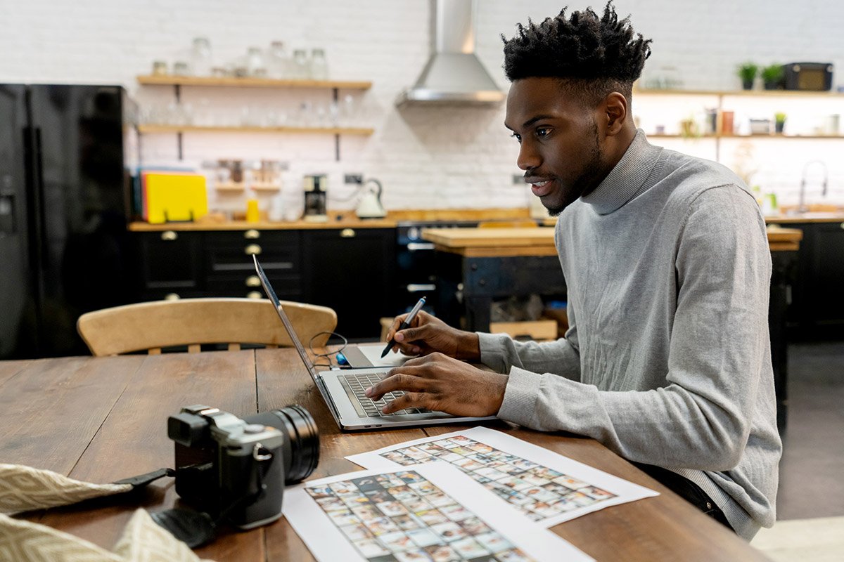 man editing photos on laptop