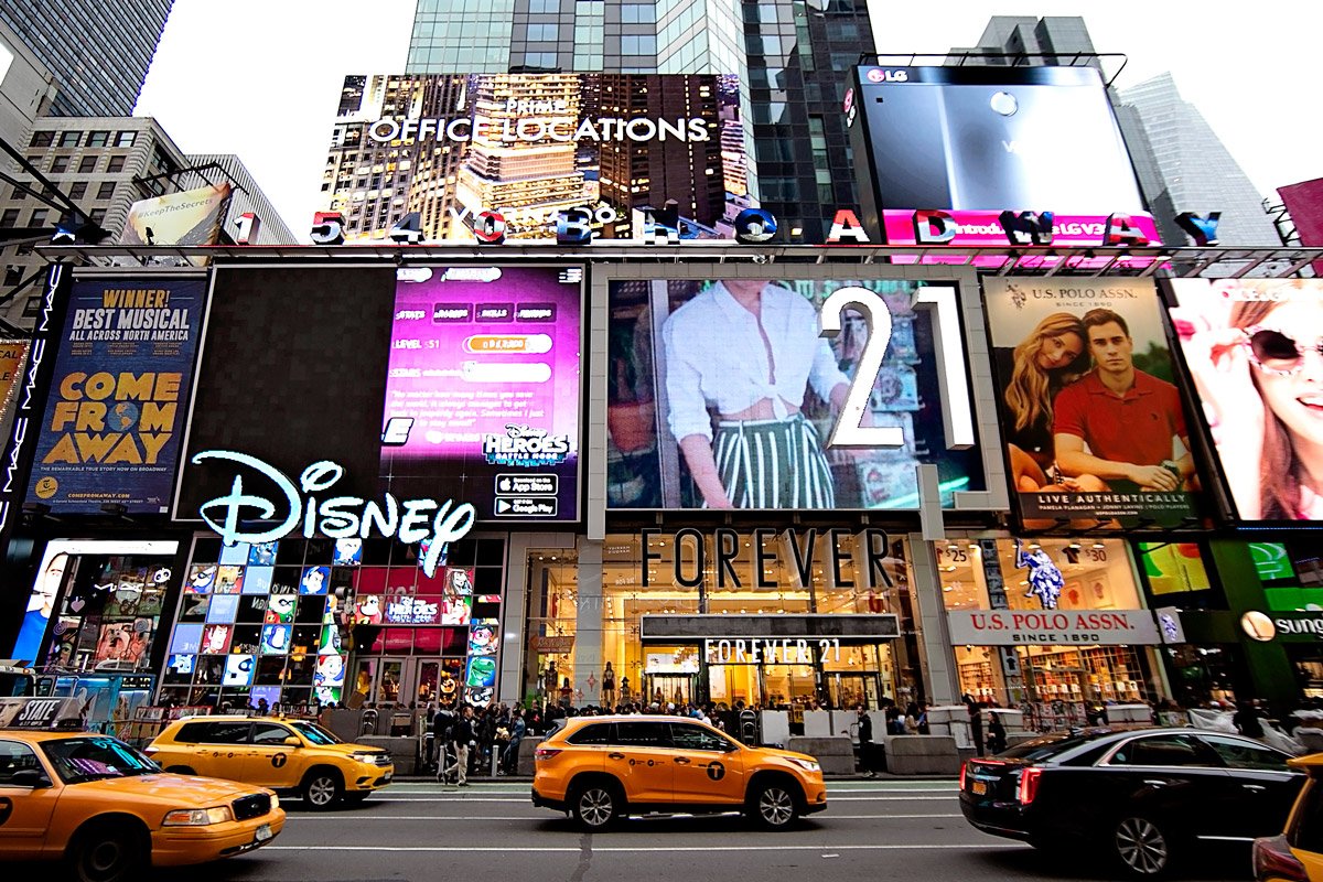 Stores line up in Time Square including Forever21 and Disney.