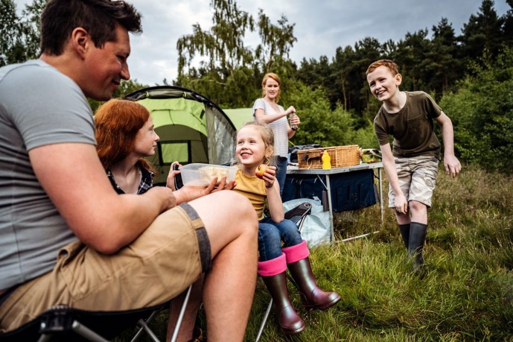 A family camps in the woods. 