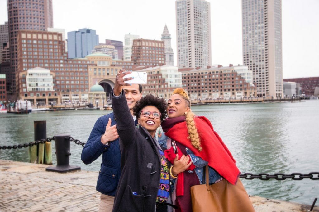 Three people take a selfie with each other in Boston.